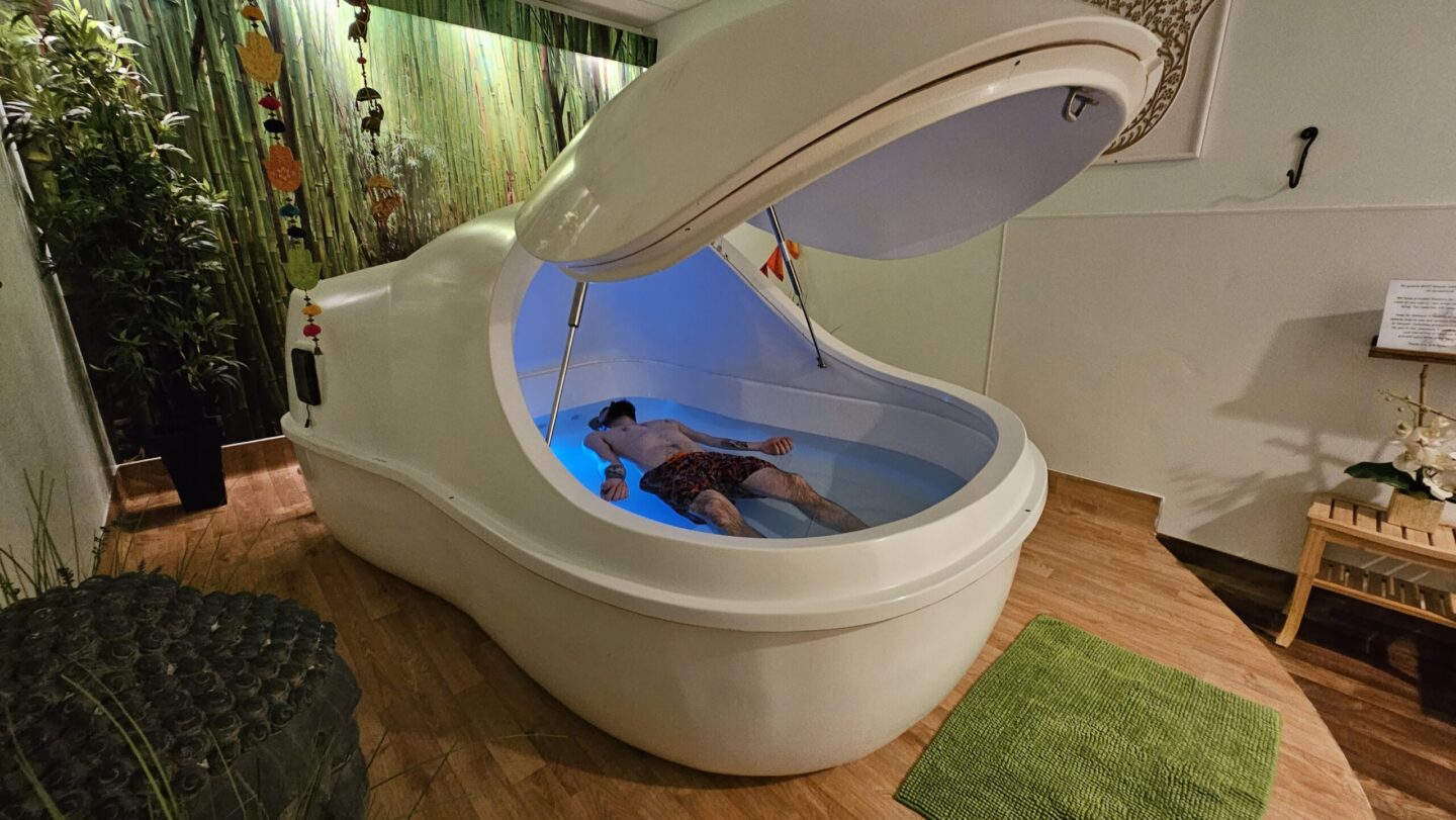 Person floating on water inside a float pod